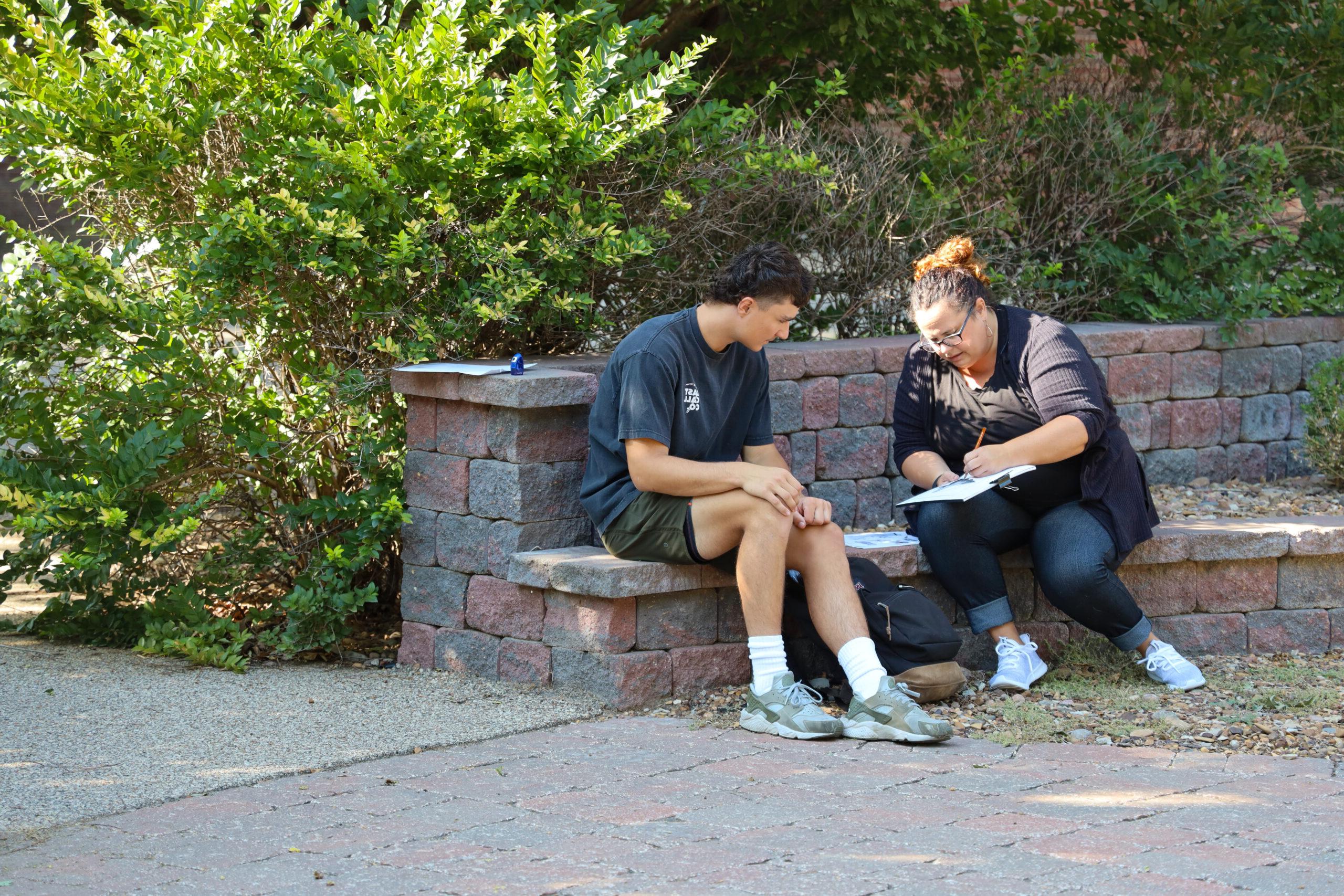 Teacher working with student outside